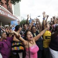 People cheer for the \"Cuban Five\" in Havana on Wednesday. They include three Cuban intelligence agents freed by the U.S. in exchange for an American aid worker and a Cuban who spied for the U.S., as Havana and Washington move to restore diplomatic ties. | REUTERS