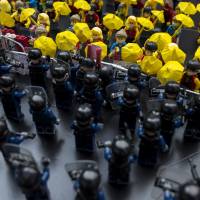 Toy Lego characters depicting pro-democracy protesters confronting riot police are seen on a table outside the government headquarters in Hong Kong in October. | REUTERS