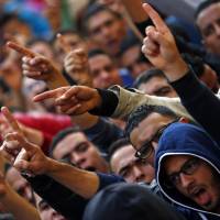 Cairo University students shout anti-government slogans Sunday condemning the verdict in former Egyptian President Hosni Mubarak\'s trial, at the university\'s campus in Giza, on the outskirts of Cairo. | REUTERS