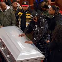 Mourners surround the casket of 28-year-old Akai Gurley during his wake Friday at Brown Memorial Baptist Church in New York. A New York City Police officer shot Gurley as he was patrolling a darkened stairwell in a public housing complex on Nov. 20. No firm statistics can say whether a spate of officer-involved deaths is a growing trend or simply a series of coincidences generating a deafening buzz in news reports and social media, but New York is bracing for more public demonstrations against alleged police violence targeting African-Americans. | AP