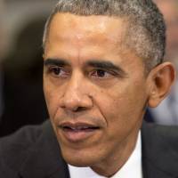 President Barack Obama speaks Dec. 12 in the White House. Obama told People magazine that every black professional male his age, including him, has had someone hand over their keys while waiting outside a restaurant. | AP