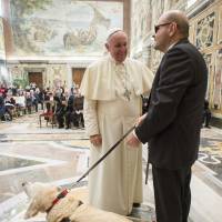 Pope Francis talks with a member of Italian Blind Union during a special audience at the Vatican on Saturday. | REUTERS