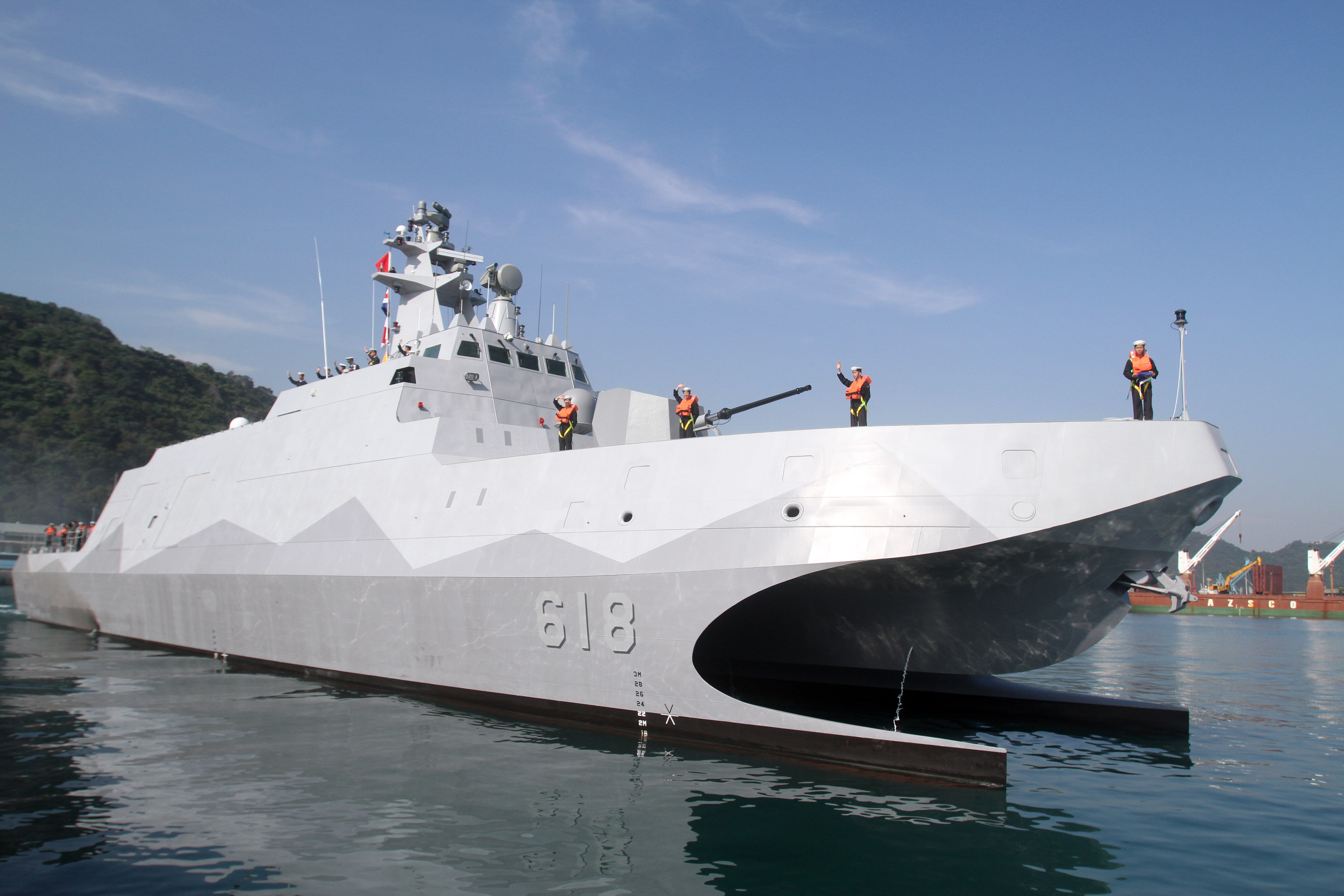 Taiwan Navy sailors and officers wave as the Taiwan-made patrol guard corvette Tuo Jiang sets sail during the handover ceremony at Suao port in Yilan county, northeast Taiwan, on Tuesday. | AP