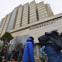 News crews set up Monday outside the National Center for Global Health and Medicine in Shinjuku Ward, Tokyo, where a man in his 30s was being tested for Ebola. | KYODO