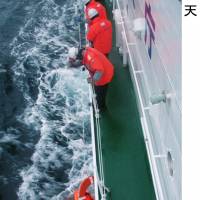 A crew member of the Cambodia-registered freighter Ming Guang is rescued from the Sea of Japan off Aomori Prefecture on Friday. | 2ND REGIONAL JAPAN COAST GUARD HEADQUARTERS/KYODO