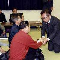 Yoshimi Watanabe, former head of the now-defunct Your Party, exchanges greetings with a supporter at a gathering in Nasushiobara, Tochigi Prefecture, on Dec. 9, ahead of last Sunday\'s Lower House snap election in which he lost his Diet seat. | KYODO