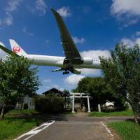 Battle overhead: A Japan Airlines airplane flies over a shrine. A new documentary titled \"The Wages of Resistance\" looks at the fights that happened during the proposed construction of Narita International Airport. | KAZUHIKO ISHII
