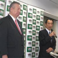 Time of crisis: JBA secretary general Yoshiki Hoshi (left) and acting JBA president Mitsuru Maruo attend a Wednesday news conference at the JBA office in Tokyo. | KAZ NAGATSUKA