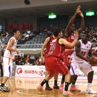 Robot rock: Tsukuba\'s Lamar Sanders is surrounded by Chiba Jets players underneath the basket in an October game in Funabashi. | KAZ NAGATSUKA