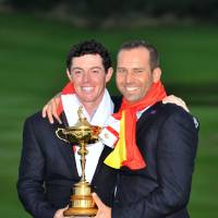 Brothers in arms: Rory McIlroy (left) and Sergio Garcia hold the Ryder Cup trophy in September. | AP