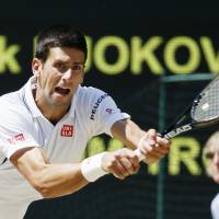 High standards: Novak Djokovic plays a shot during his semifinal win over Grigor Dimitrov at Wimbledon in July. | KYODO