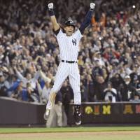Derek Jeter celebrates after hitting a walk-off single in the ninth inning of his final game at Yankee Stadium in September. Jeter ended his 20-year career after the season. | KYODO