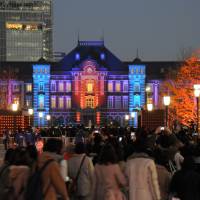 Tokyo Station is illuminated Wednesday. The building marked its centenary last weekend, when rail fans overwhelmed a promotional sale of commemorative Suica cards. The lighting can be viewed through Sunday. | SATOKO KAWASAKI