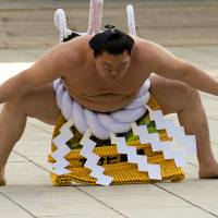 Mongolian-born grand sumo champion Yokozuna Hakuho performs the New Year\'s ring-entering rite Wednesday at the annual celebration for the New Year at Meiji Shrine in Tokyo. | REUTERS