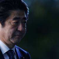 Japan\'s Prime Minister Shinzo Abe arrives at his official residence in Tokyo on Friday. | REUTERS