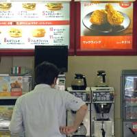 A man waits to place his order at a McDonald\'s in Tokyo. The fast-food chain has recently been hit with a series of incidents in which foreign objects have been found by customers in chicken nuggets sold in Japan. | BLOOMBERG