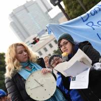 Australian activist Catherine Fisher (left) addresses the crowd outside the Diet via translator Meri Joyce (right). | FINBAR O\'MALLON