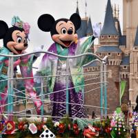 Disney characters Mickey Minnie Mouse, dressed in traditional Japanese kimonos, greet guests from a float during the theme park\'s annual New Year\'s Day parade at Tokyo Disneyland on Thursday. | AFP-JIJI