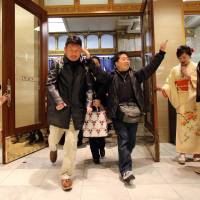 Shoppers rush into a Tokyo department store on Jan. 2 to buy \"lucky bags\" containing items worth three times their price tags to celebrate a new year of business. | AFP-JIJI