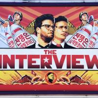 This December 25, 2014 file photo shows a poster for \"The Interview\" displayed on the marquee of the Los Feliz 3 cinema  in Los Angeles. Sony Pictures said Wednesday it had expanded distribution of the controversial comedy to include more theaters and video-on-demand platforms, after hackers threatened to attack cinemas screening the film. | AFP-JIJI