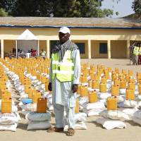 An official stands in front of  relief materials at a camp for displaced people in Maiduguri in Nigeria\'s Borno State on Tuesday. More than 1 million people may have been forced to leave their homes in northern Nigeria by the five-year-old insurgency of Islamist sect Boko Haram, a United Nations agency said. Now African nations are seeking a U.N. mandate to collectively combat the jihadis. | REUTERS