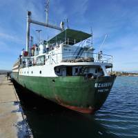 Border police inspect the \"ghost ship\" Ezadeen on Saturday, after some 350 Syrian refugees it had been carrying disembarked at the Italian port of Corigliano. | AFP-JIJI
