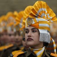 Indian policewomen take part in a rehearsal for the Republic Day parade in Srinagar on Saturday. India celebrated its annual Republic Day on Monday. In talks with U.S. President Barack Obama a day earlier, Indian Prime Minister Narendra Modi signaled a shift in his government\'s thinking on climate change. | REUTERS