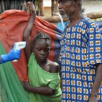 Liberian residents are quarantined in Omega town, a suburb of Monrovia, after one of their relatives died from Ebola on Wednesday. The World Health Organization said in its latest update that 8,688 people had died, among a cumulative total of 21,759 cases. Liberian health officials said Friday that there are only five Ebola cases remaining in the stricken country. | AFP-JIJI