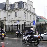 Motorcycle policemen arrive at the Charleville-Mezieres police station in northeastern France on Thursday where the youngest of three men being sought in connection with the deadly attack on the Paris offices of satirical weekly Charlie Hebdo, turned himself in and was taken into custody late the night before. | AFP-JIJI
