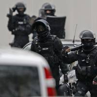 Members of the French Research and Intervention Brigade (BRI), a special police force, get to work at the scene of a street shooting in Montrouge near Paris on Thursday as the manhunt widened for two brothers suspected of killing 12 people at a satirical magazine in an apparent Islamist militant strike. Police sources could not immediately confirm a link with the killings at the Charlie Hebdo weekly newspaper, which marked the worst attack on French soil for decades and which national leaders and allied states described as an assault on democracy. | REUTERS