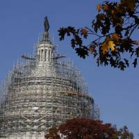 The scaffolding surrounding the U.S.Capitol Dome is seen in November. An Ohio man claiming sympathy with Islamic State militants was arrested Wednesday in connection with a plot to attack the U.S. Capitol with guns and bombs, court documents disclosed. | REUTERS