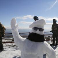 Peacekeepers with UNIFIL, the United Nations Interim Force in Lebanon, are pictured with a snowman which they took time out to build in the village of Kfar Kila, near the border with Israel, on Sunday. | REUTERS