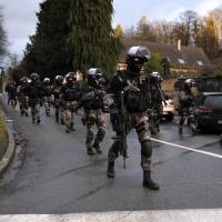 French police special forces patrol in Corcy, northern France, on Jan. 8 as part of a massive manhunt for the gunmen who shot dead 12 people in an Islamist attack at the Paris offices of the French satirical weekly Charlie Hebdo a day earlier. | AFP-JIJI