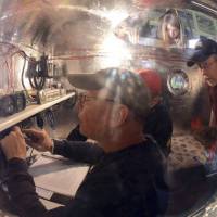 Bert Padelt (foreground) prepares the Two Eagles capsule for launch in Saga Prefecture in this handout photo released Wednesday. | REUTERS