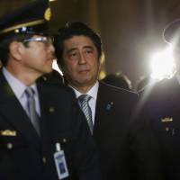 Prime Minister Shinzo Abe walks to attend the opening day of the Diet session in Tokyo on Monday. | REUTERS