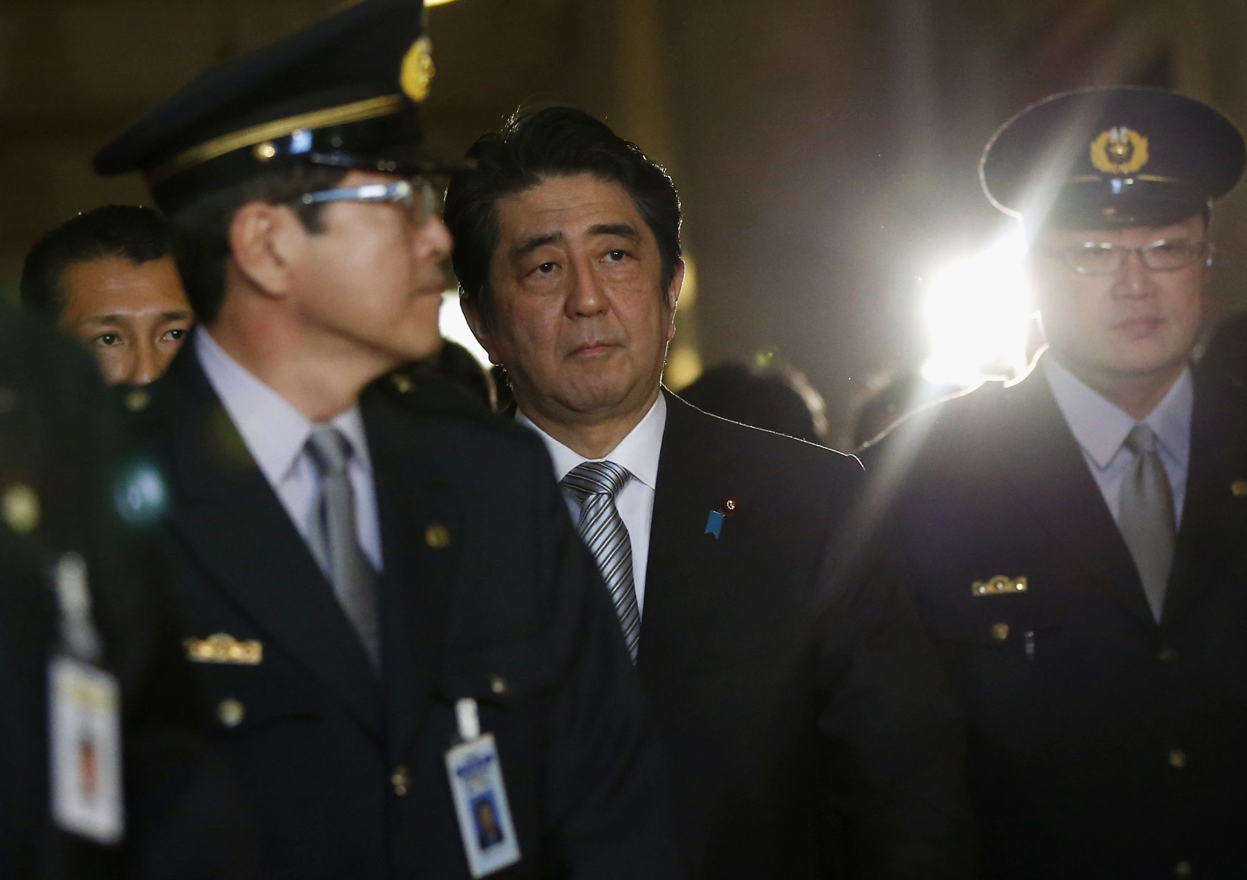 Prime Minister Shinzo Abe walks to attend the opening day of the Diet session in Tokyo on Monday. | REUTERS