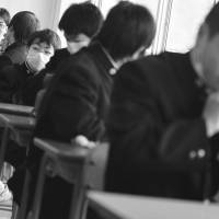 Children chat in a classroom in Kesennuma, Miyagi Prefecture, at the start of the school year in April 2011. Online bullying is often hard for adults to detect and can escalate to serious levels. | AP