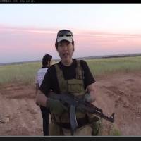Haruna Yukawa, one of two Japanese hostages held by the Islamic State group, appears in a video on his YouTube channel handling an AK-47 last year in Aleppo, Syria. He has described himself as a security professional, but his motives for wanting to join militants there remain unclear. | YOUTUBE