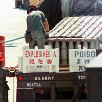 U.S. Army personnel prepare to transport mustard gas shells out of Okinawa Prefecture in July 1971. | KYODO