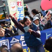 Protesters against the proposed transfer of U.S. Marine Corps Air Station Futenma to the Henoko coastal district of Okinawa Prefecture rally outside the Diet on Sunday. | FINBAR O\'MALLON