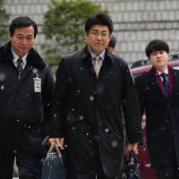 Tatsuya Kato arrives for trial at a court in Seoul on Dec. 15. Authorities on Thursday extended a ban on his leaving the country by another three months. | AFP-JIJI