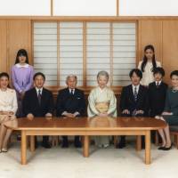 Emperor Akihito (front, third at left) and Empress Michiko (front, center) pose with their family during a photo session for the new year at the Imperial Palace in Tokyo on Nov. 18. Seen with them are Crown Princess Masako (front left), Crown Prince Naruhito (front, second left), Prince Akishino (front, third at right), Prince Hisahito (front, second at right), Princess Kiko (front right), Princess Aiko (back left) and Princess Kako (back right). | REUTERS