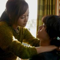 Life in a love hotel: Toru (Shota Sometani), the manager of a love hotel, is embraced by his girlfriend, Saya, played brilliantly by Atsuko Maeda in \"Sayonara Kabukicho (Kabukicho Love Hotel).\" | &#169; 2014 \"SAYONARA KABUKICHO\" SEISAKU IINKAI
