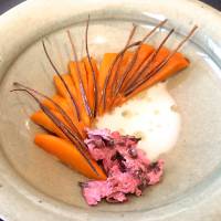 Slivers of simmered pumpkin, paired with dried cherry blossoms, is just one of 16 courses at Noma Japan. | ROBBIE SWINNERTON