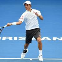 Sublime: Kei Nishikori plays a shot from Bernard Tomic in their quarterfinal match at the Brisbane International on Friday. Nishikori won 6-0, 6-4. | AFP-JIJI