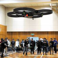 A drone hovers during the Japan Drone Championship held in Tokyo\'s Akihabara district Sunday. The winner was Toru Takahashi, who beat 17 rivals in a time trial race around an oval course. | YOSHIAKI MIURA