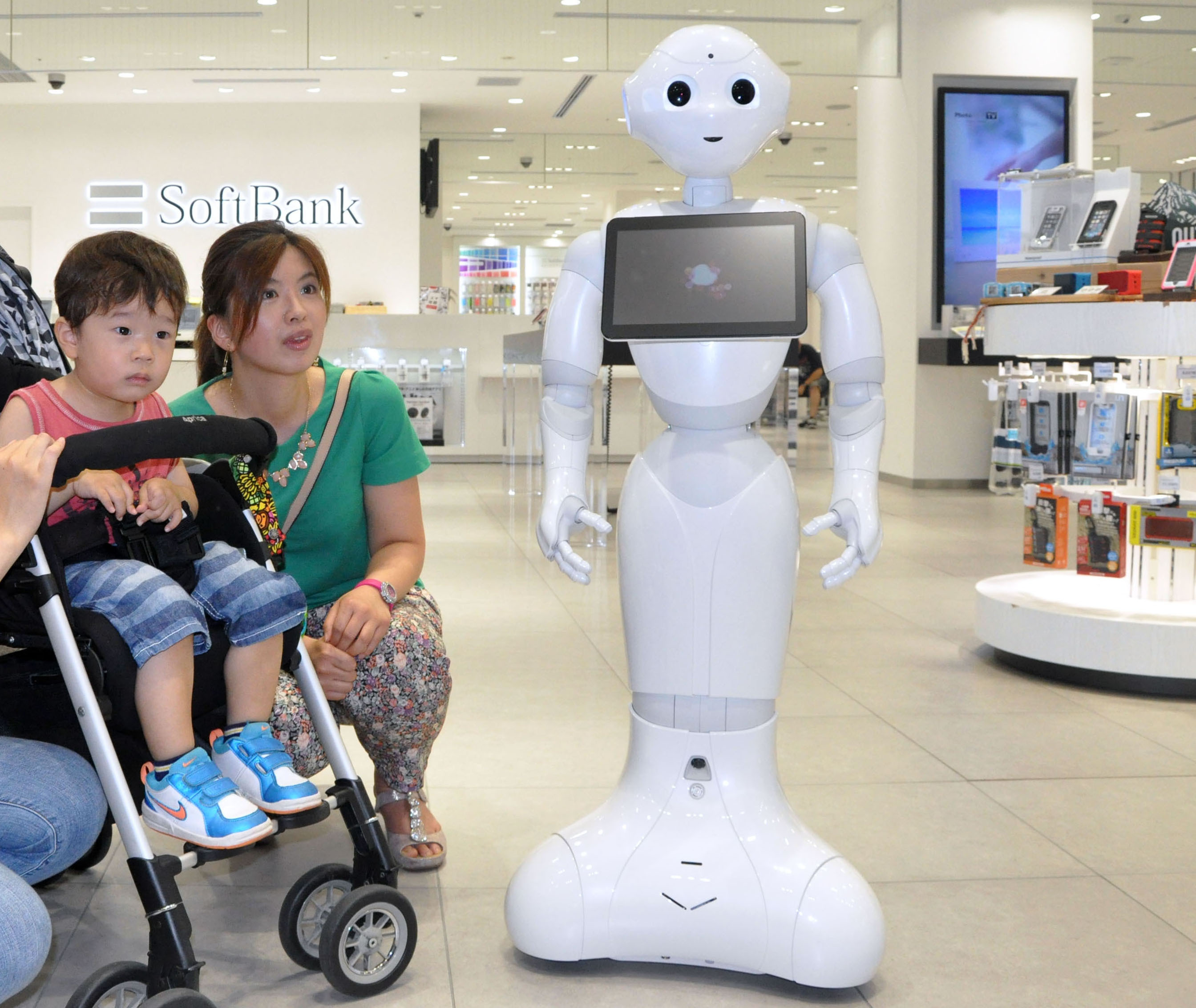 Unveiled in June, 2014, 'Pepper,' a humanoid robot that can communicate with people and sense emotions, made its debut as a clerk at a SoftBank Corp. mobile phone store in July. SoftBank has further developed an application, which can help prevent dementia through conversations and ask questions to perform a simple diagnosis of symptoms. | KYODO