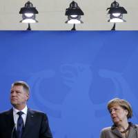 Romanian President Klaus Iohannis and German Chancellor Angela Merkel address a news conference at the Chancellery in Berlin on Thursday.  | REUTERS