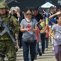 Japanese soldiers escort people Sunday during a Non-Combatant Evacuation/Transportation of Japanese Nationals Overseas exercise as part of the annual combined military exercises coined Cobra Gold 2015 at a military base in Sattahip.  | AFP-JIJI