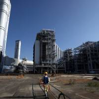 Tokyo Electric Power Co.\'s combined-cycle thermal power station in Kawasaki is pictured in August. The nation\'s top utility and Chubu Electric Power Co. will unite their thermal power operations in a joint venture with a dominating market share. | BLOOMBERG